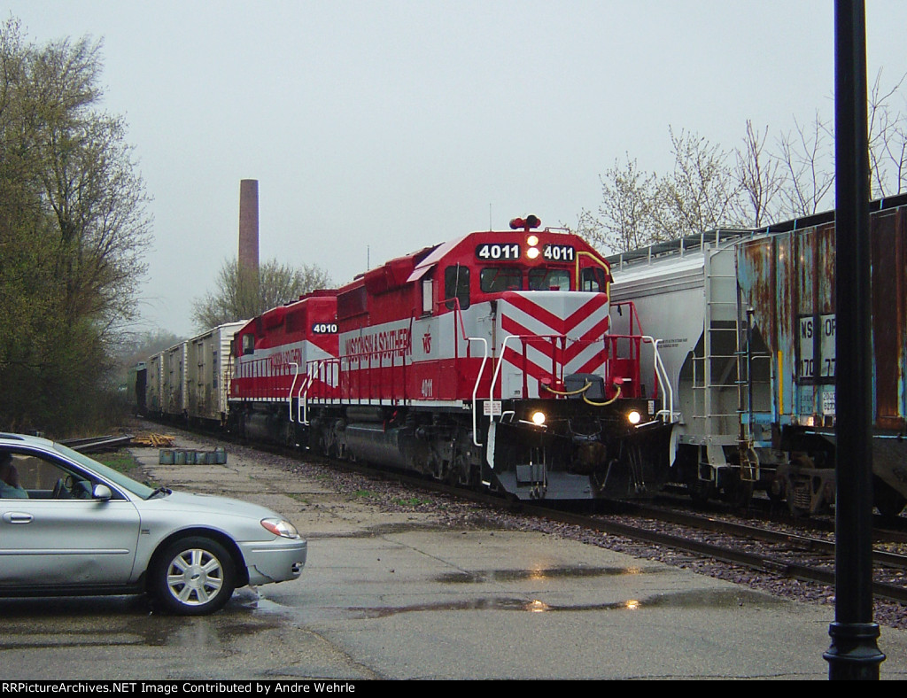 WSOR 4011 leads 4010 and 5 cars to Janesville on a rainy Saturday